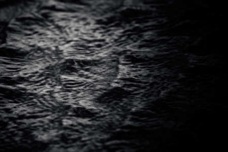 Abstract image waves with surface of dark water in swimming pool.の写真素材