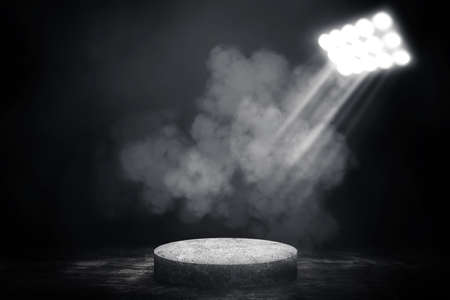 Empty space of Concrete podium or pedestal in studio dark room black concrete floor grunge texture background with smoke and spotlight.の写真素材