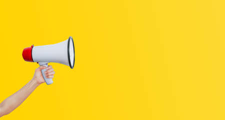 Business Communication and Marketing Concept : Female hand holding megaphone for announcement and...