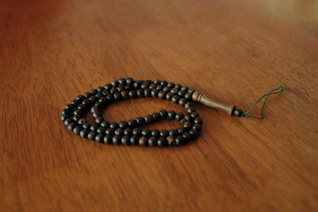 Tasbih or prayer bead on the wooden table