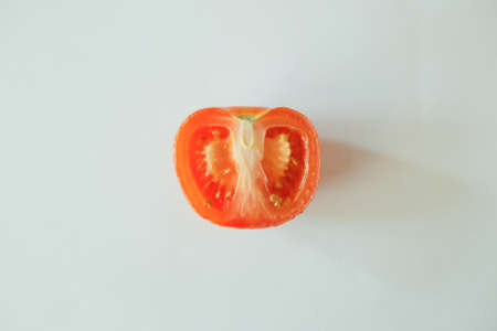 Half slice tomato isolate on white backgroundの写真素材