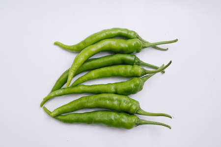 Group of fresh green chili peppers isolated on white background