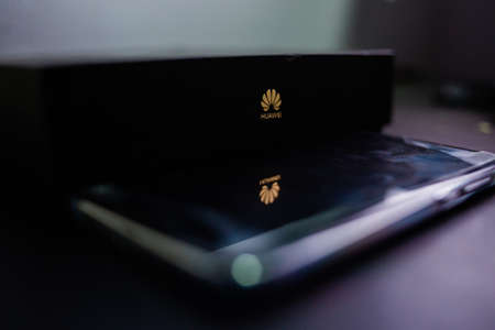 PERAK, MALAYSIA - MAY 24, 2019:The close up photo of Huawei logo on huawei mobile box and reflection...