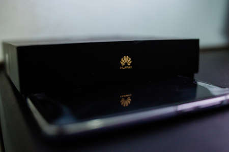 PERAK, MALAYSIA - MAY 24, 2019:The close up photo of Huawei logo on huawei mobile box and reflection of the Huawei logo on the smartphone.のeditorial素材