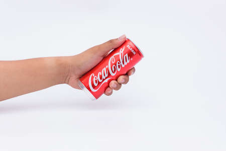 PERAK, Malaysia - August 11, 2019. Holding a can of Coca Cola isolated on white background.のeditorial素材