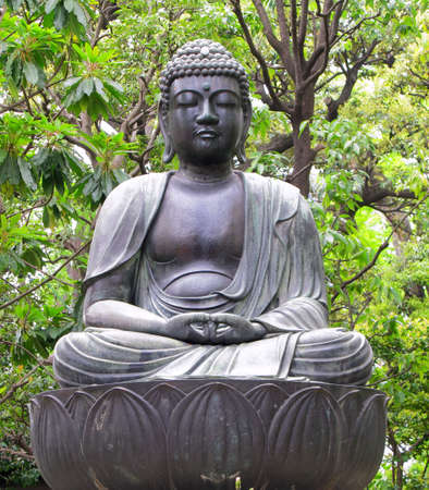Seated Buddha statue at temple in Tokyo, Japan.の写真素材