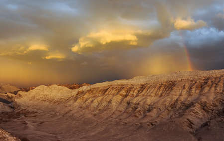Thunderstorm developing over sand dune in Valle De La Luna in the Atacama Desert near San Pedro de Atacama, Chile. The Atacama Desert is one of the driest places on earth, and these storms are rare.の写真素材