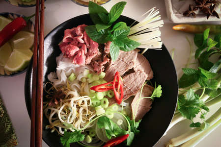 Preparing Pho, Vietnamese rice noodles, with beef and other materials