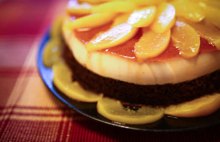 Cake with dark chocolate and peach mousse, and are decorated with slices of peaches on topの写真素材