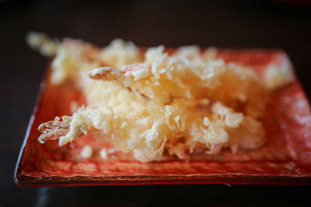 Japanese foods include sushi, nigiri, sashimi, served on small plate on a wooden backgroundの写真素材