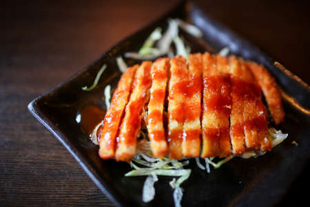 Japanese foods include sushi, nigiri, sashimi, served on small plate on a wooden backgroundの写真素材