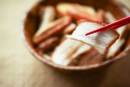 Chinese fry pork chops into small pieces and served with chopsticksの写真素材
