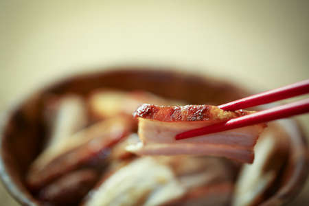 Chinese fry pork chops into small pieces and served with chopsticks