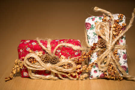 Small gift boxes on a wooden surface in a closeup viewの写真素材