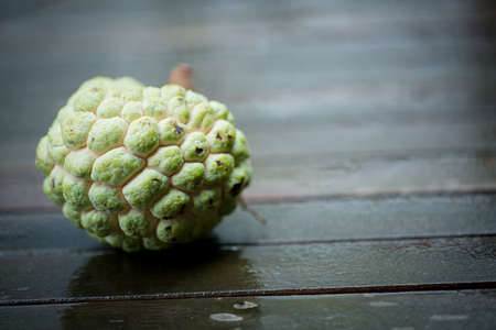 Annona squamosa or sugar-apple on a rustic wooden background