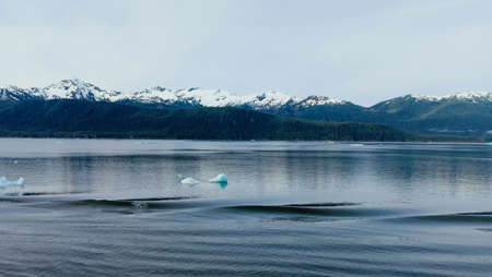 snow covered mountain and oceanの写真素材