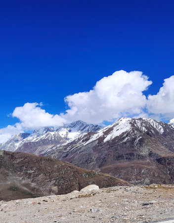 snow covered mountain in Manali Himachal Pradesh , a view from roadside , beautifull mountain under clear blue sky during sunny dayの写真素材