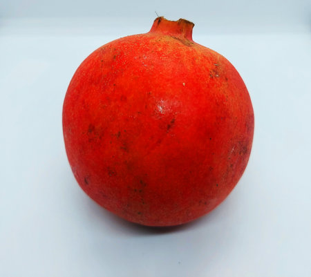 ripe pomegranate isolated in white backgroundの写真素材
