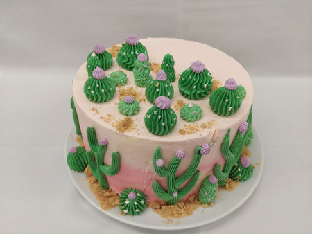 Cake decorated with cactus on a white background in a restaurant, cactus theam cakeの写真素材