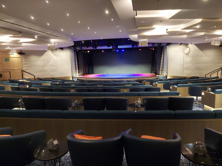 Cinema auditorium with seats and a large screen on the wallの写真素材