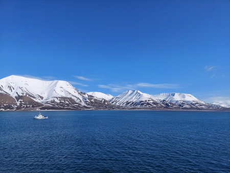 Serene Winter Landscape: Majestic Mountains, Pristine Snow, and Tranquil Sea a view from svalbard and jan mayen norwayの写真素材