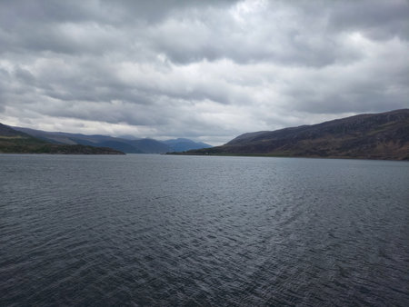 Tranquil Scene: Serene Landscape with Mountain, Lake, and Overcast Sky   a view from ukの写真素材