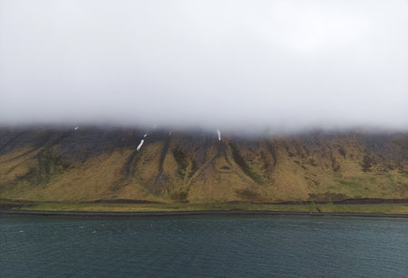 Misty fog over tranquil Icelandic landscape, showcasing the beauty of nature.の写真素材