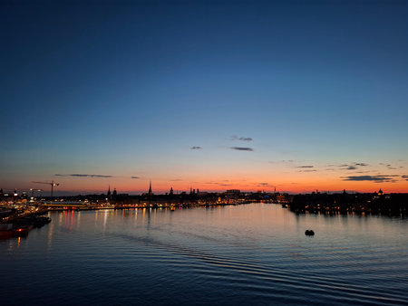 stockholm sweden Scenic Evening Skyline Reflecting Over Calm Waterfront at Sunsetの写真素材