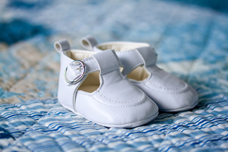Pair of white baby shoesの写真素材