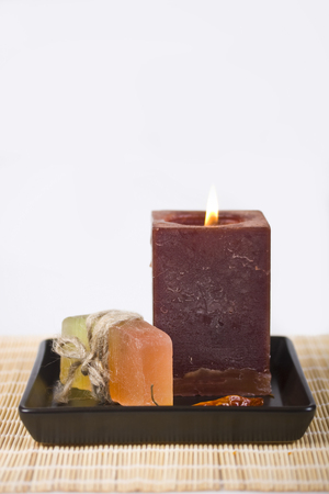 Soap and candle on a white backgroundの写真素材