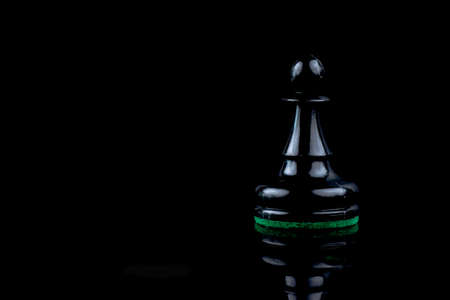 Black and white plastic chess pieces on separated backgroundの写真素材