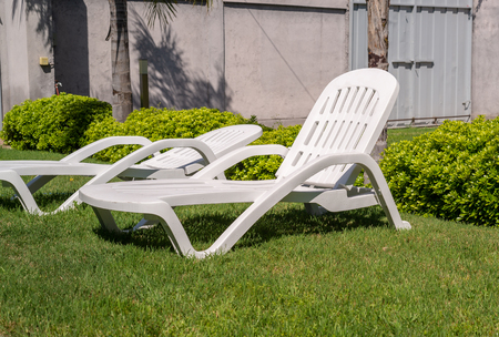 sunbeds and tropical garden. They are used for relaxation and leisure activities.