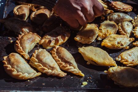 kitchen fountain with fresh homemade Empanadas (detailed close-up shot; selective focus)の写真素材