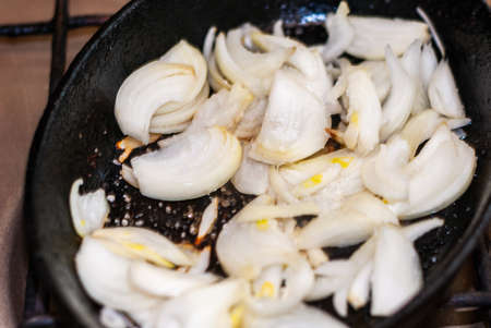 Frying onion. Minced onion in frying pan.selective focus.の写真素材
