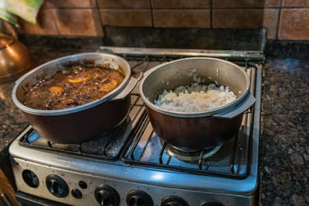 Typical Brazilian dish called Feijoada. Made with black beans, pork and sausage. Served on a white plate during a meeting.の写真素材