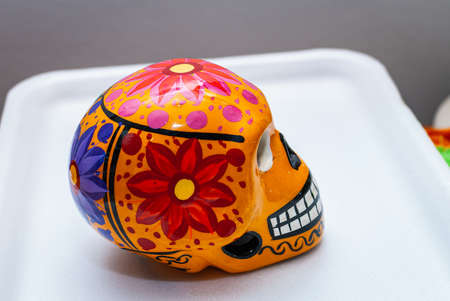 Green Painted human skull with flowers for Mexico's Day of the Dead on color background, selected focus.の写真素材