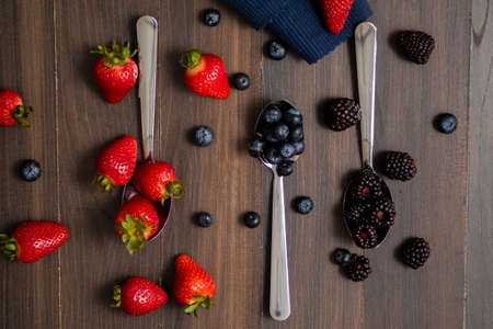 Close-up image of berries isolated, blueberry, strawberry, blackberry, spoonの写真素材