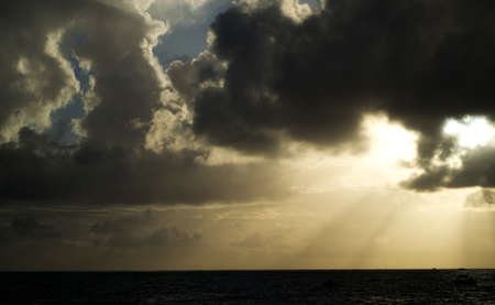 Rays of light shining through dark clouds. dramatic sky with cloud.