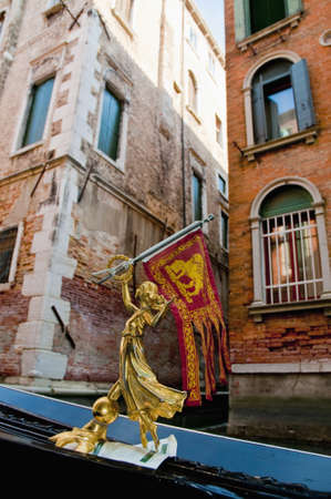 Small golden statue detail on a gondola at Venice, Italyの写真素材
