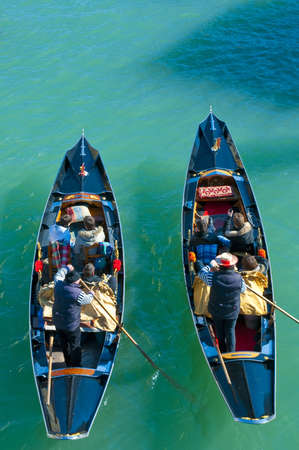 Two gondolas full of people seen from above at Venice, Italyの写真素材