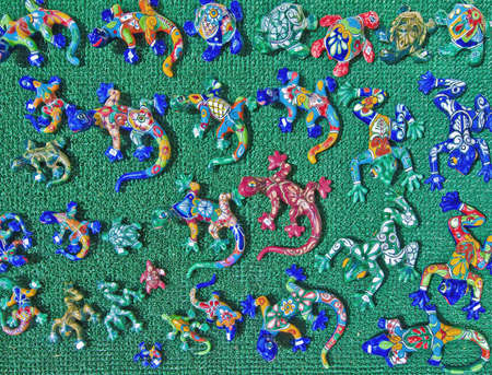Colorful ceramic lizards over a green backgroundの写真素材