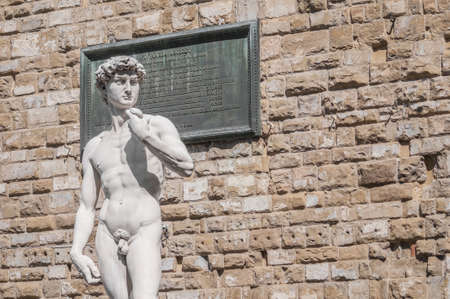 Copy of Michelangelo's David statue standing in its original location, in front of the Palazzo Vecchio at Piazza della Signoria in Florence, Italyのeditorial素材