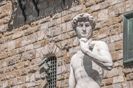 Copy of Michelangelo's David statue standing in its original location, in front of the Palazzo Vecchio at Piazza della Signoria in Florence, Italyの写真素材