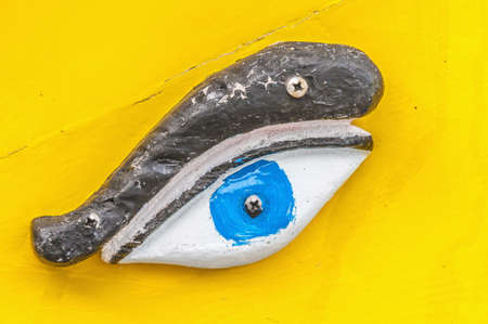 Eye of Horus or Osiris in traditional Luzzu boat at Marsaxlokk harbor, a fishing village located in...
