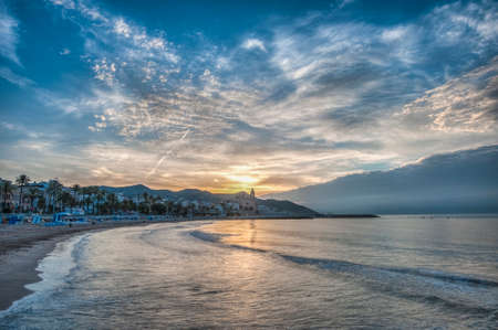 Sun sets on Sitges village on southern Barcelona in Catalonia Province, Spainの写真素材