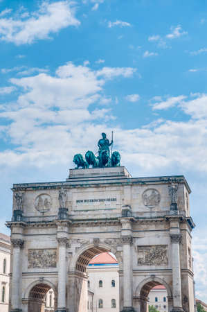 The Victory Gate (Siegestor), a three-arched triumphal arch crowned with a statue of Bavaria with a lion-quadriga in Munich, Germanyのeditorial素材