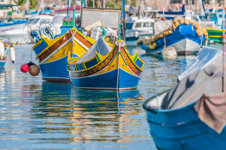 Traditional Luzzu boat at Marsaxlokk harbor, a fishing village located in the south-eastern part of Malta.の写真素材