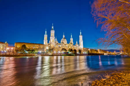 Our Lady of the Pillar Basilica as seen from the north shore of Ebro River at Zaragoza, Spainのeditorial素材