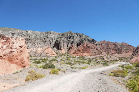 Los Colorados path in Purmamarca, near Cerro de los Siete Colores (The Hill of Seven Colors), in the...