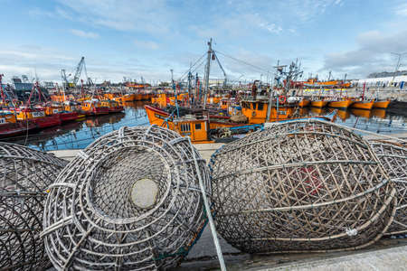 Typical orange fishing boats on the port of the coastal city of Mar del Plata in Buenos Aires province, Argentinaのeditorial素材